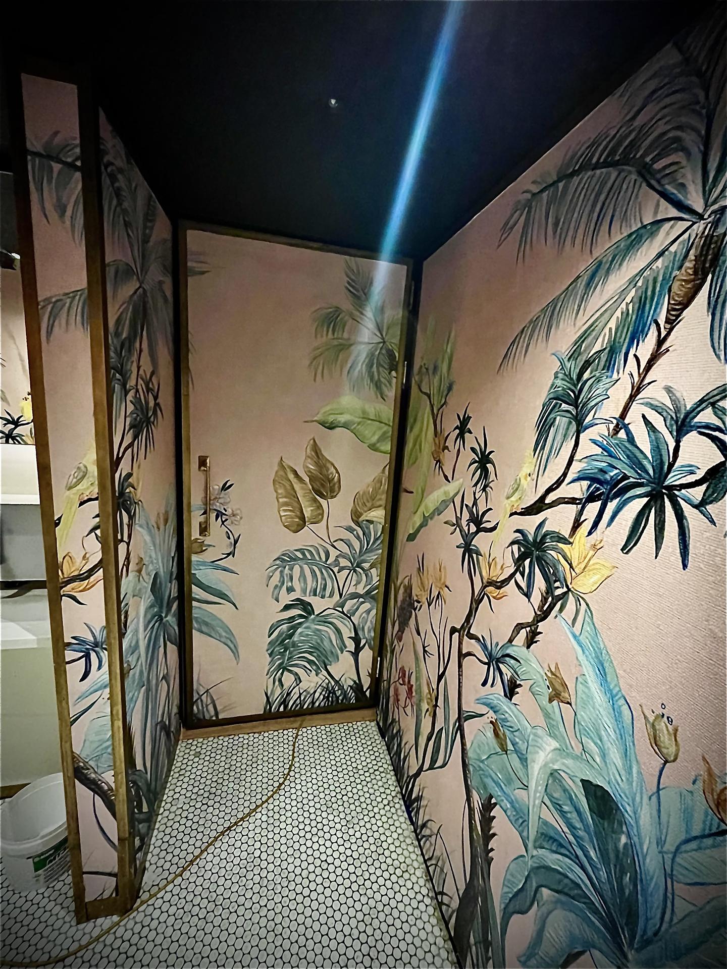 Pink botanical wallpaper finished restaurant toilet cubicle, London